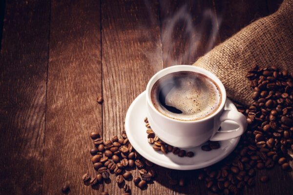 Cup coffee beans wooden dark background